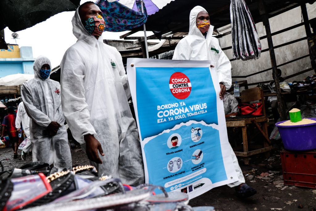 Members of the pro-democracy and civil society movement FILIMBI carry out a public educational campaign about coronavirus in a market in Congo's capital Kinshasa in May. Justin Makangara for Fondation Carmignac
